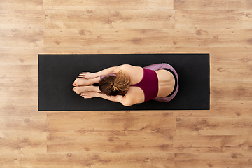 Image showing woman doing yoga exercise on mat at studio