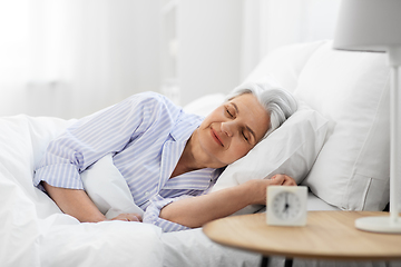 Image showing senior woman sleeping in bed at home bedroom