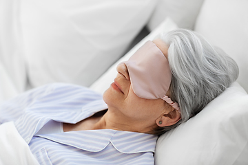 Image showing senior woman with eye mask sleeping in bed at home