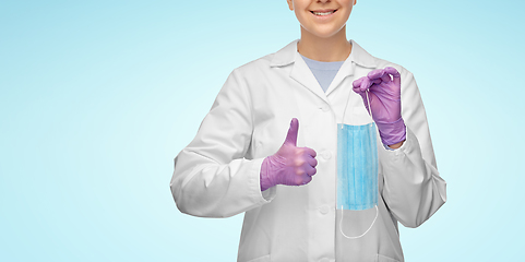 Image showing female doctor with medical mask showing thumbs up