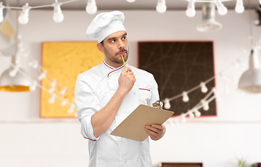 Image showing thinking male chef with clipboard at restaurant