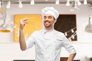 Image showing happy smiling male chef with chopsticks