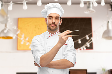 Image showing serious male chef with chopsticks