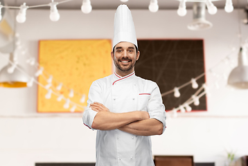 Image showing happy smiling male chef in toque with crossed arms