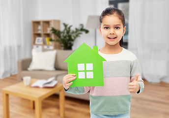 Image showing smiling little girl with green house icon at home