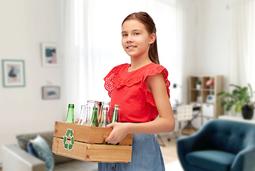 Image showing smiling girl sorting glass waste at home