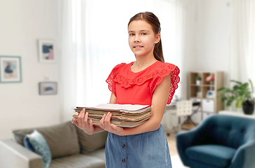 Image showing smiling girl sorting paper waste at home