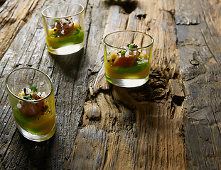 Image showing Snack from salmon and puree from avocado in a glass. Film effect