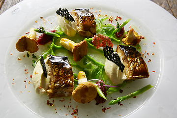 Image showing Grilled Foods. Grilled Fish with chanterelles with greens.