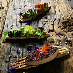 Image showing Three portions of homemade dessert fresh berries on a wooden background