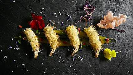 Image showing Shrimp fried in rice noodles. Snack from shrimps. High kitchen. Film effect.