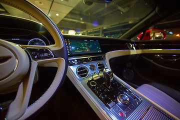 Image showing Car interior luxury. Interior of prestige modern car. Dashboard and steering wheel. Focus on steering wheel.