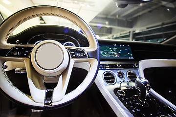 Image showing Car interior luxury. Interior of prestige modern car. Dashboard and steering wheel. Focus on steering wheel.