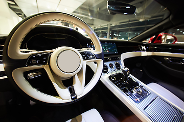 Image showing Car interior luxury. Interior of prestige modern car. Dashboard and steering wheel. Focus on steering wheel.