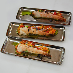 Image showing Delicious appetizer of shrimps with vegetables in chrome plates.