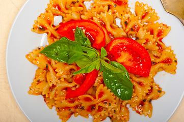 Image showing Italian pasta farfalle butterfly bow-tie and tomato sauce