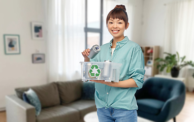 Image showing smiling young asian woman sorting metallic waste