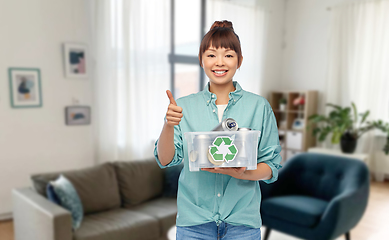 Image showing smiling young asian woman sorting metallic waste