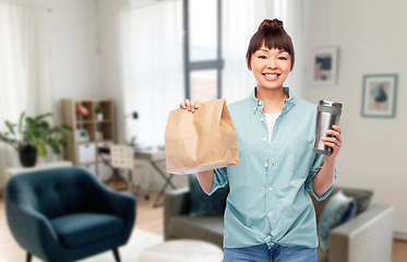 Image showing woman with paper bag and tumbler for hot drinks