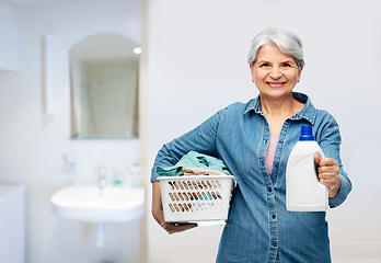 Image showing smiling senior woman with laundry basket