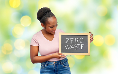 Image showing happy woman holds chalkboard with zero waste words