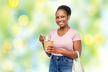 Image showing happy woman with reusable bag for food and wok