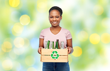 Image showing happy african american woman sorting glass waste