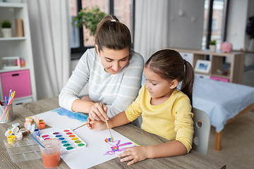 Image showing mother with little daughter drawing at home