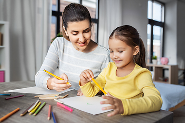 Image showing mother with little daughter drawing at home