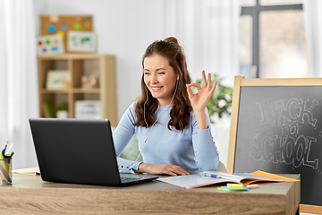 Image showing teacher with laptop having online class at home