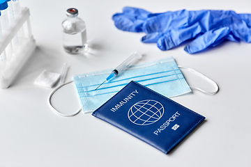 Image showing immunity passport, mask, syringe, vaccine on table