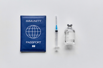 Image showing immunity passport, syringe and vaccine on table