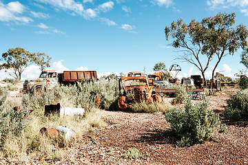 Image showing Rusty cars trucks and other items in the desert