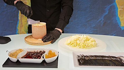 Image showing Special cheese knives. The girolle scraper. Making cheese shavin