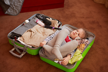 Image showing Cute little child inside a big suitcase.