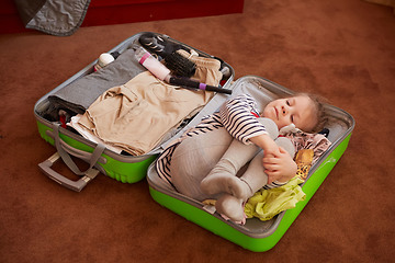 Image showing Cute little child inside a big suitcase.