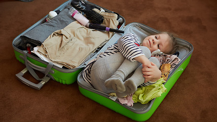 Image showing Cute little child inside a big suitcase.