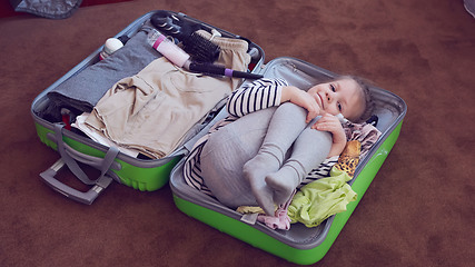 Image showing Cute little child inside a big suitcase.