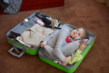 Image showing Cute little child inside a big suitcase.