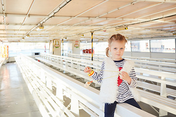 Image showing trendy little girl have a fun in the empty excursion ship.