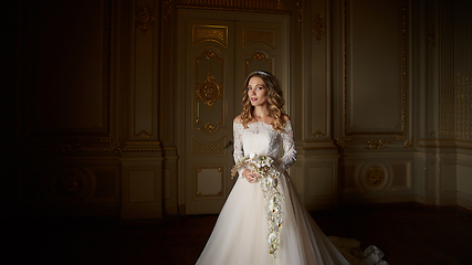 Image showing Beautiful bride with bouquet in luxury interior in the Baroque style.