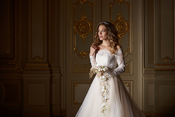 Image showing Beautiful bride with bouquet in luxury interior in the Baroque style.