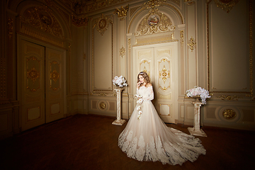 Image showing elegant stylish bride looking at rich interior in old building