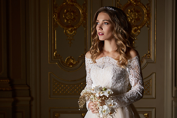 Image showing Beautiful bride with bouquet in luxury interior in the Baroque style.