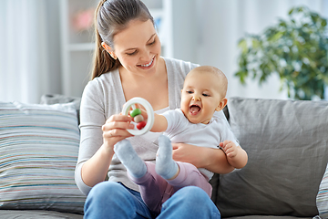 Image showing mother and little baby playing with rattle at home