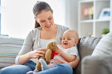 Image showing mother with baby playing with teddy bear at home