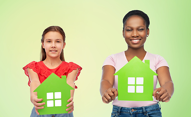 Image showing african woman and caucasian girl with green houses