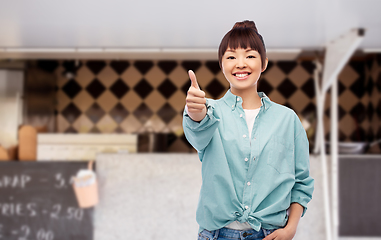 Image showing asian woman showing thumbs up over food truck