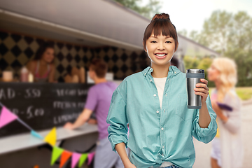 Image showing woman with thermo cup or tumbler over food truck