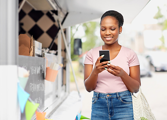 Image showing woman with smartphone over food truck